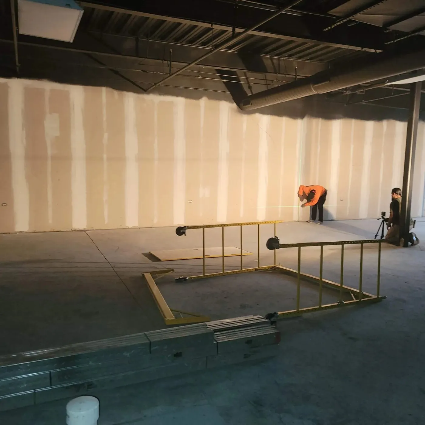Jamaica Works crew working on framing and drywall in a commercial build-out